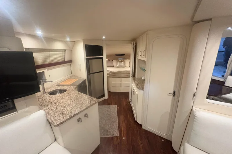 Slide: The Image of Interior of 1996 Carver 38 Santego yacht with white seating and wooden table. - 20