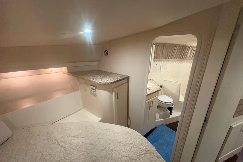 Slide: The Image of Interior of 1996 Carver 38 Santego yacht with modern kitchen and cozy bedroom. - 22