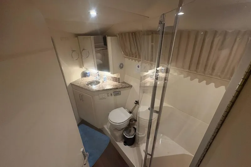 Slide: The Image of Interior of 1996 Carver 38 Santego yacht, featuring cozy cabin and bathroom. - 24