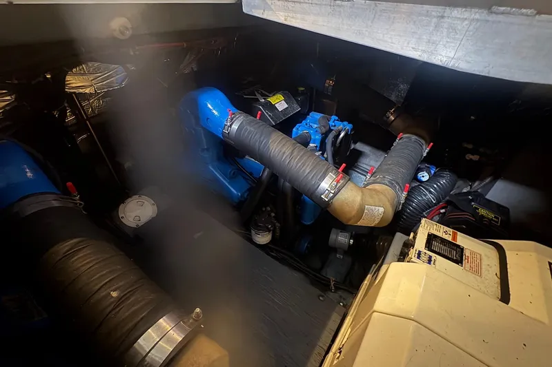Slide: The Image of Engine room of a 1996 Carver 38 Santego boat, featuring blue and black components. - 29
