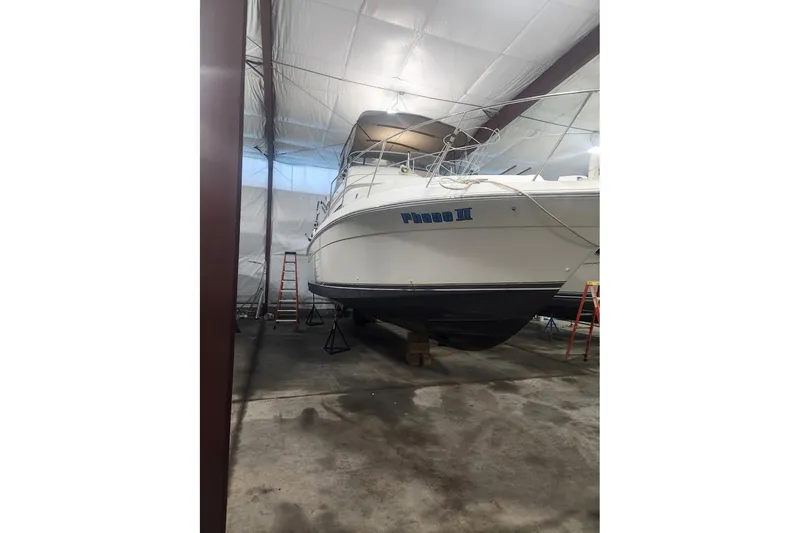 Slide: The Image of 1996 Carver 38 Santego boat stored indoors, supported by stands. - 30