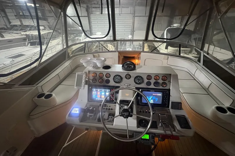 Slide: The Image of Interior view of 1996 Carver 38 Santego yacht with helm and seating area. - 7