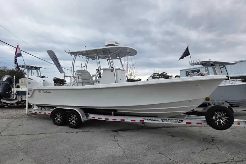 The Image of 2024 Pair Customs 27 Center Console boat on trailer, displayed outdoors. - 0