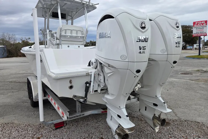 Slide: The Image of 2024 Pair Customs 27 Center Console boat with twin Yamaha 300 V6 engines on trailer. - 4