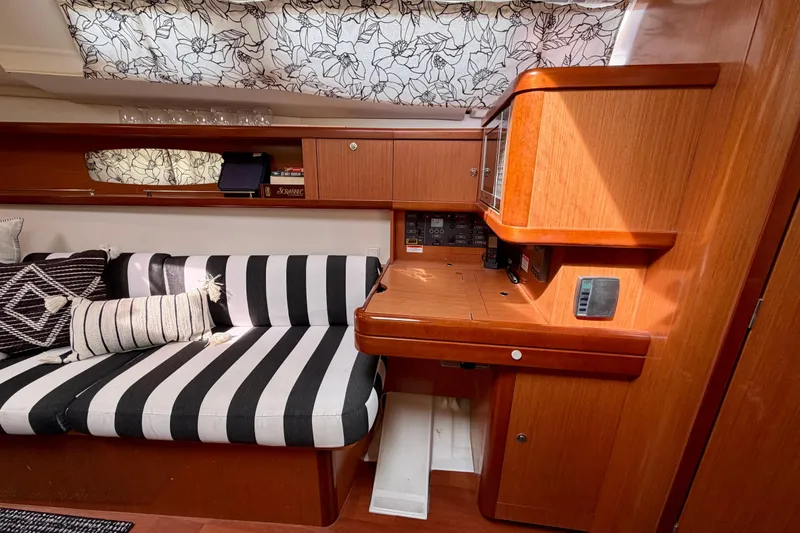 Slide: The Image of Interior of 2008 Beneteau Oceanis 37 yacht with striped seating and wooden cabinetry. - 11