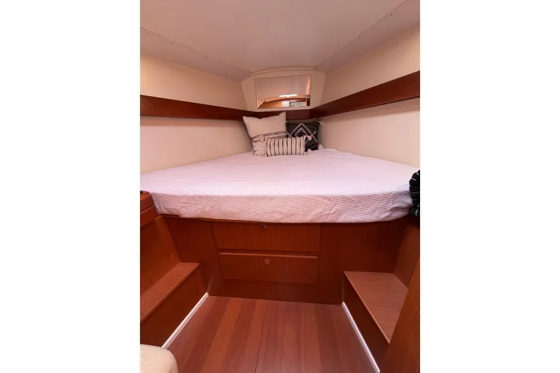 Slide: The Image of Cozy cabin interior of 2008 Beneteau Oceanis 37 sailboat with wooden finish and bedding. - 15