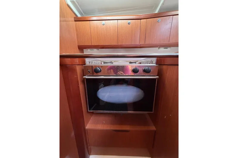 Slide: The Image of Wooden interior of 2008 Beneteau Oceanis 37 yacht with built-in oven. - 26