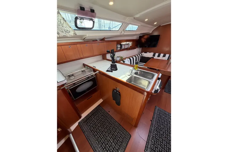 Slide: The Image of Interior of 2008 Beneteau Oceanis 37 yacht with kitchen and seating area. - 27