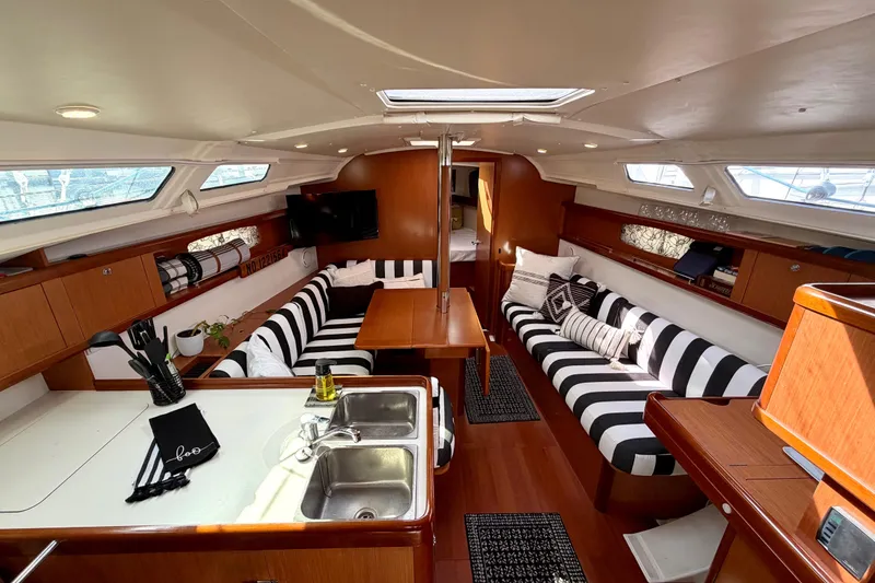 Slide: The Image of Interior of 2008 Beneteau Oceanis 37 sailboat with striped seating and wooden finishes. - 3