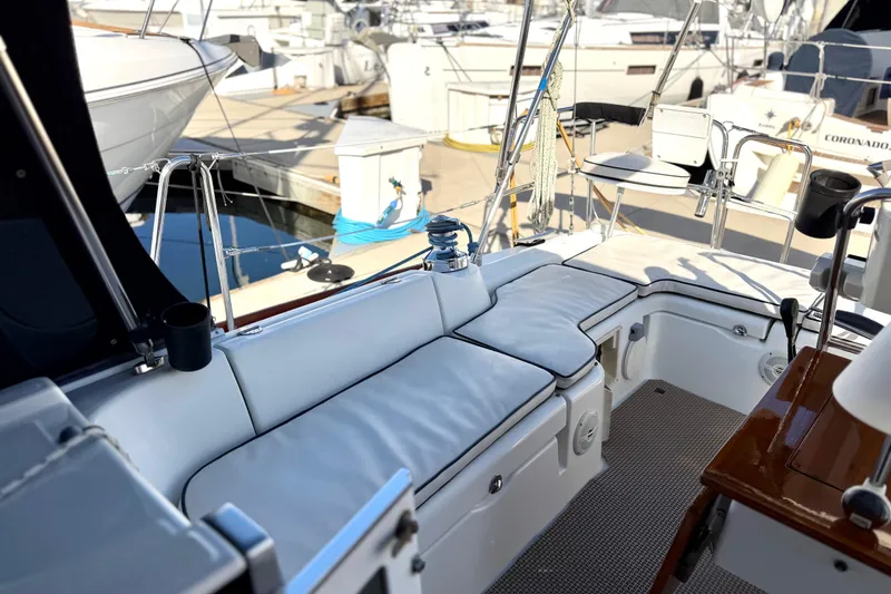 Slide: The Image of 2008 Beneteau Oceanis 37 sailboat cockpit with cushioned seating at marina. - 34