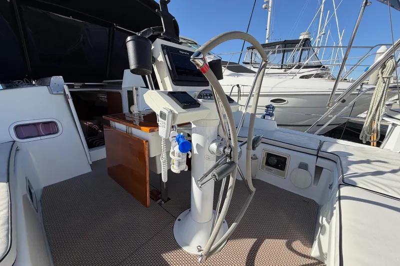 Slide: The Image of Cockpit of 2008 Beneteau Oceanis 37 sailboat with steering wheel and navigation equipment. - 37