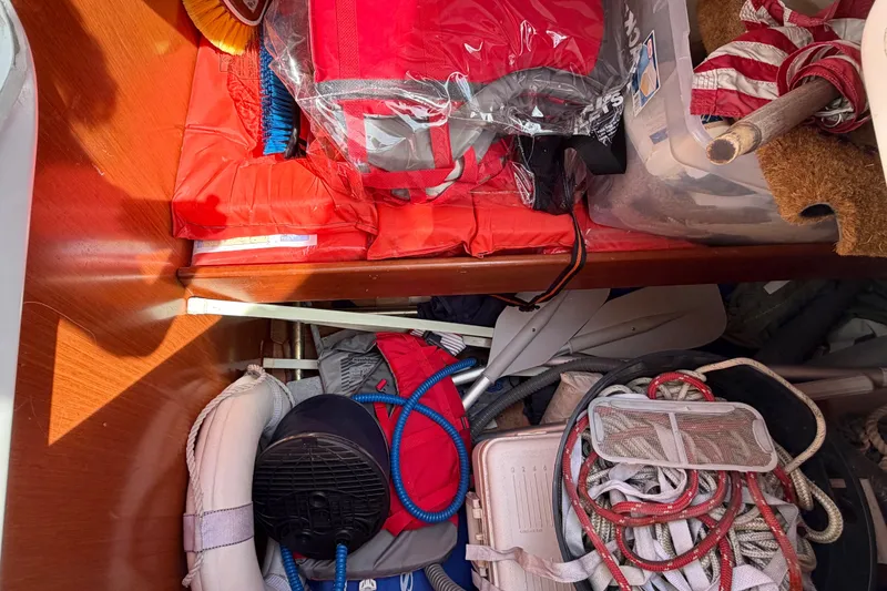 Slide: The Image of Storage compartment of a 2008 Beneteau Oceanis 37 sailboat with life jackets and ropes. - 51