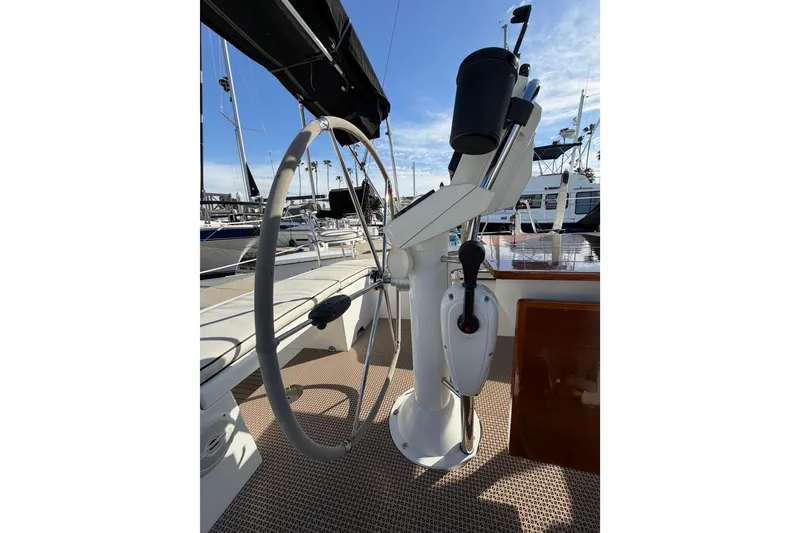 Slide: The Image of Steering wheel of a 2008 Beneteau Oceanis 37 sailboat in a marina setting. - 52