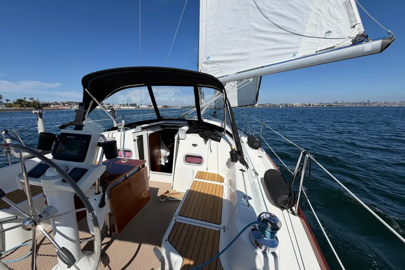 Slide: The Image of 2008 Beneteau Oceanis 37 sailboat on open water, featuring cockpit and sails. - 55