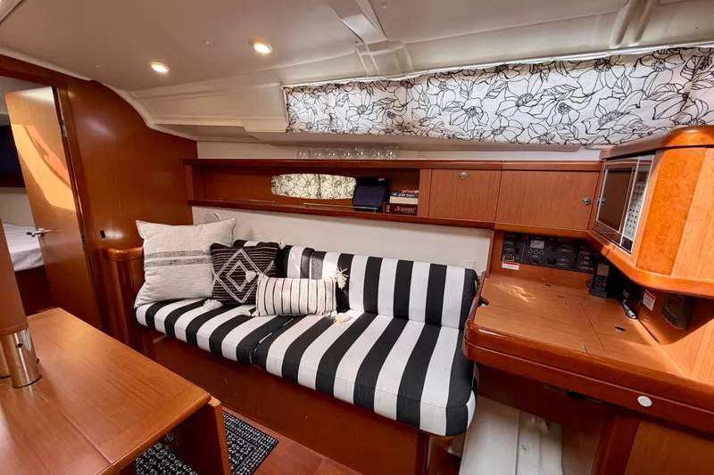 Slide: The Image of Luxurious interior of 2008 Beneteau Oceanis 37 yacht with striped sofa and wooden cabinetry. - 9