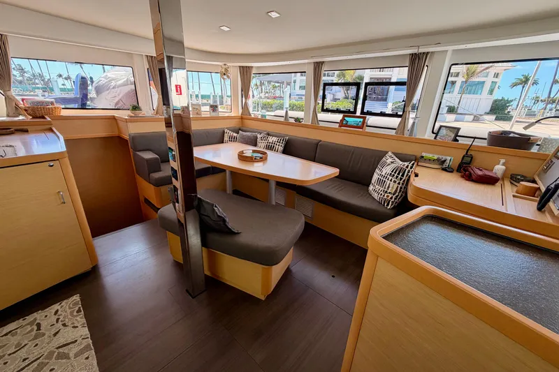 Slide: The Image of Interior of 2017 Lagoon 42 catamaran with modern seating and large windows. - 14