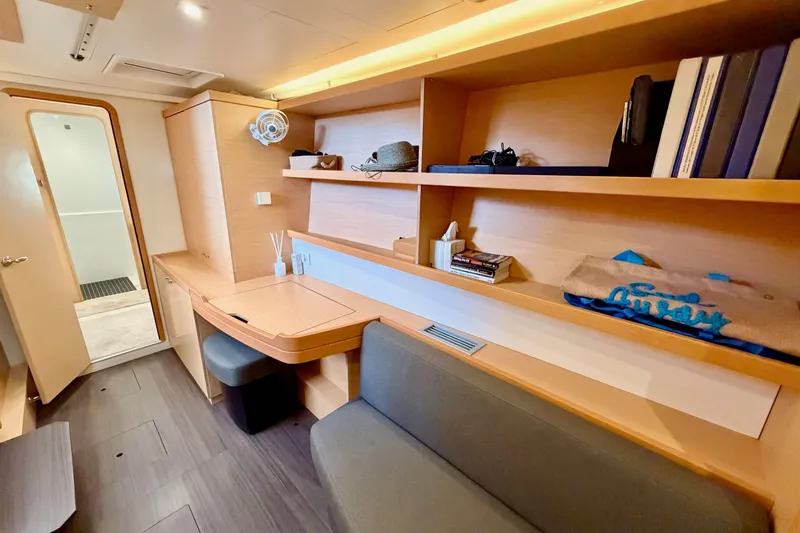 Slide: The Image of Interior of 2017 Lagoon 42 yacht with modern wooden shelves and seating area. - 20