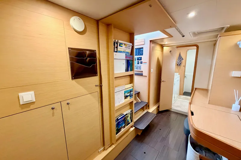Slide: The Image of Interior of 2017 Lagoon 42 yacht with wooden cabinetry and bookshelves. - 21
