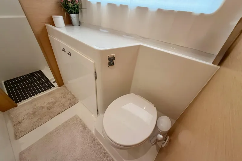 Slide: The Image of Modern bathroom in 2017 Lagoon 42 yacht with toilet, storage, and decor. - 23