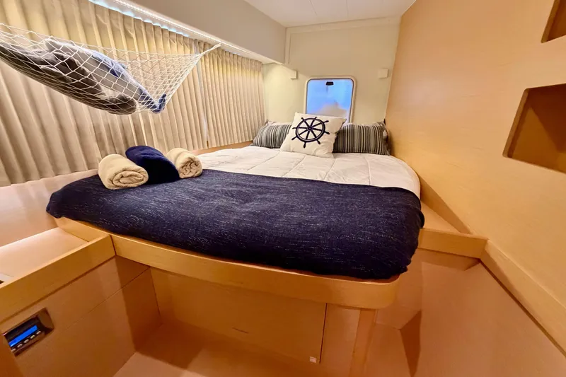 Slide: The Image of Luxurious cabin interior of 2017 Lagoon 42 catamaran with cozy bedding and nautical decor. - 25