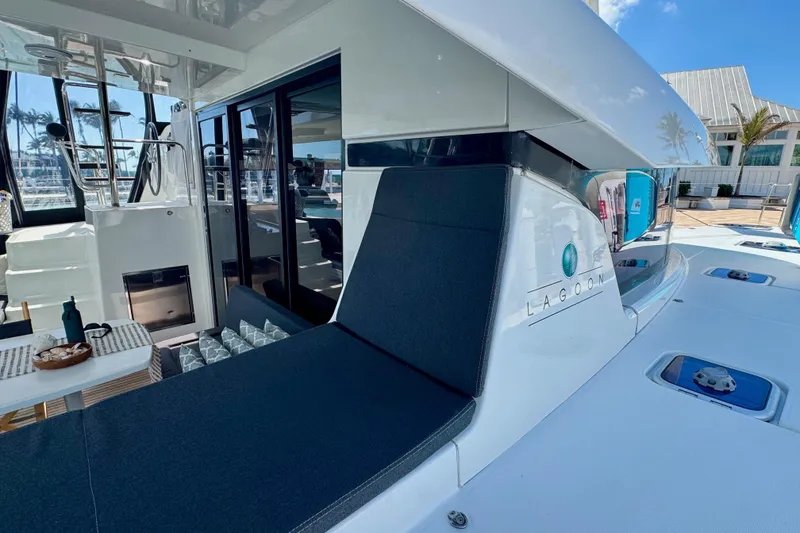 Slide: The Image of 2017 Lagoon 42 catamaran with sleek design, outdoor seating, and modern amenities. - 3