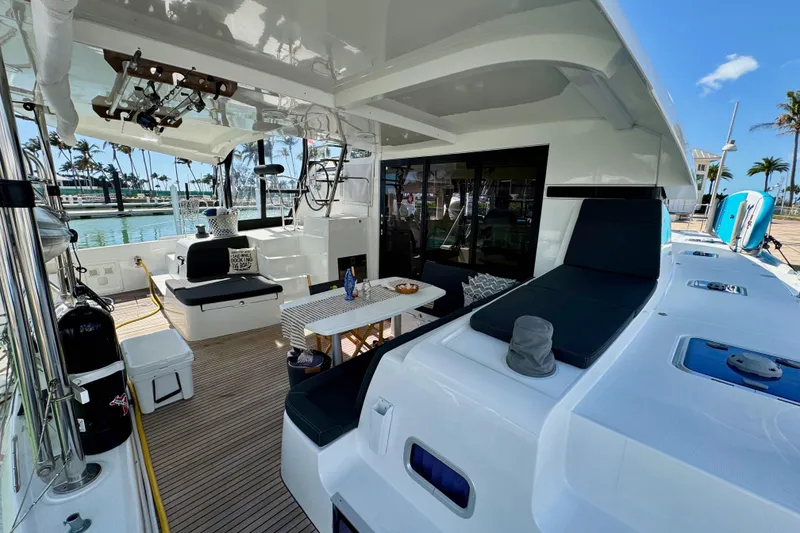 Slide: The Image of Spacious deck of 2017 Lagoon 42 catamaran with seating and dining area, docked at marina. - 4