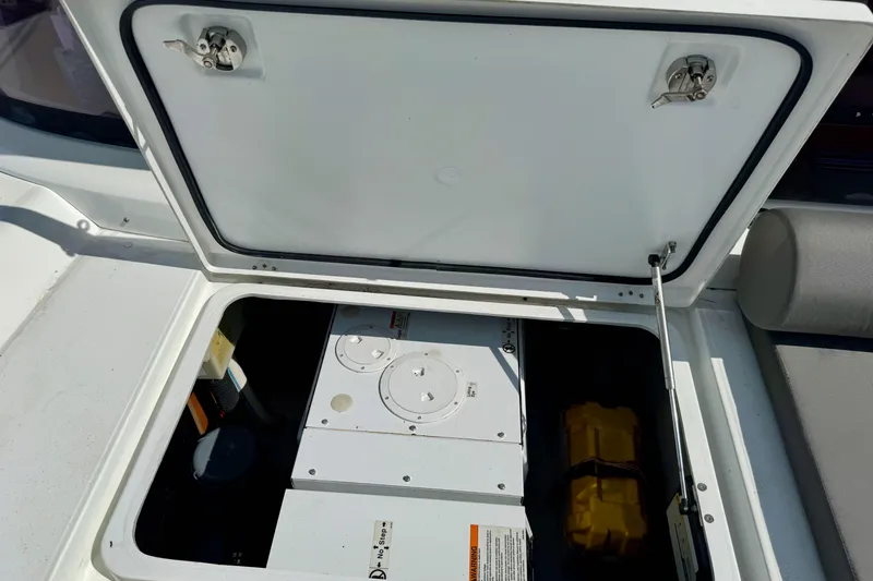 Slide: The Image of Open hatch on 2017 Lagoon 42 catamaran, revealing storage compartment and equipment. - 8