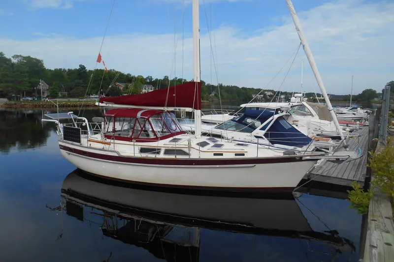The Image of 1987 Irwin 38 Mk II sailboat docked in a serene marina setting. - 1
