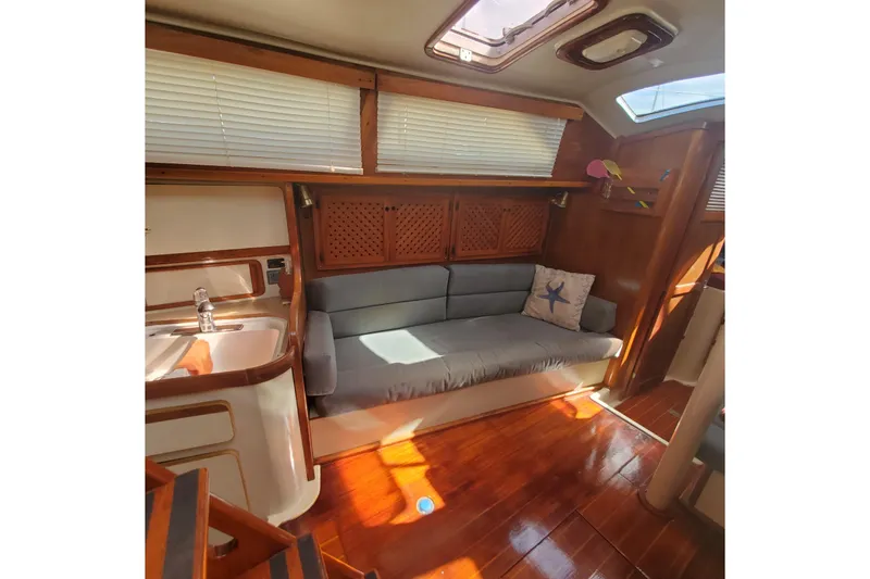 Slide: The Image of Cozy interior of 1987 Irwin 38 Mk II sailboat with wooden finishes and cushioned seating. - 10