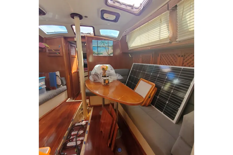 Slide: The Image of Interior of 1987 Irwin 38 Mk II sailboat with solar panel and wooden furnishings. - 13