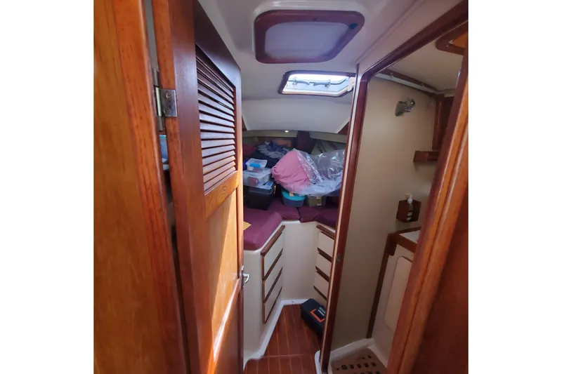 Slide: The Image of Interior of 1987 Irwin 38 Mk II sailboat with wooden cabinetry and storage space. - 14