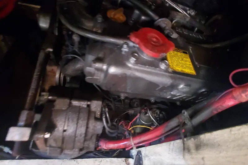 Slide: The Image of Engine compartment of a 1987 Irwin 38 Mk II sailboat, featuring mechanical components and wiring. - 16