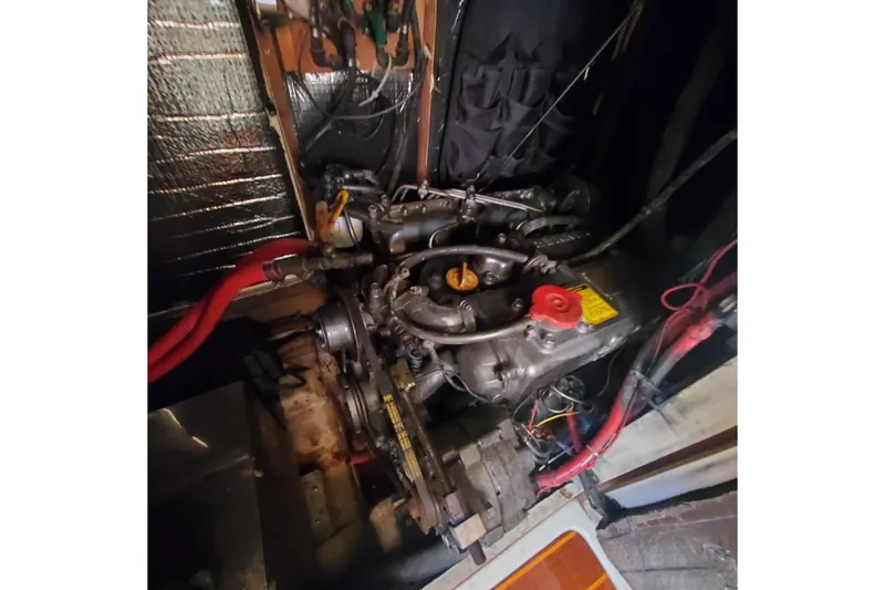 Slide: The Image of Engine compartment of a 1987 Irwin 38 Mk II sailboat, showing mechanical components and wiring. - 19