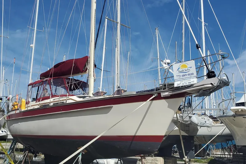 Slide: The Image of 1987 Irwin 38 Mk II sailboat with maroon canopy, docked in a marina. - 3
