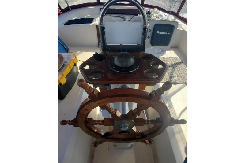 Slide: The Image of Cockpit of 1987 Irwin 38 Mk II sailboat with wooden steering wheel and navigation equipment. - 5