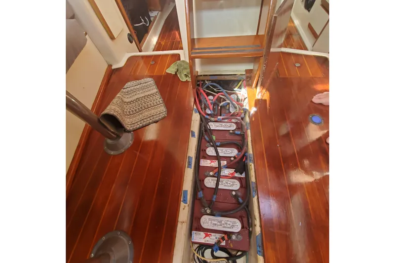 Slide: The Image of 1987 Irwin 38 Mk II sailboat interior showing battery compartment and wooden flooring. - 8