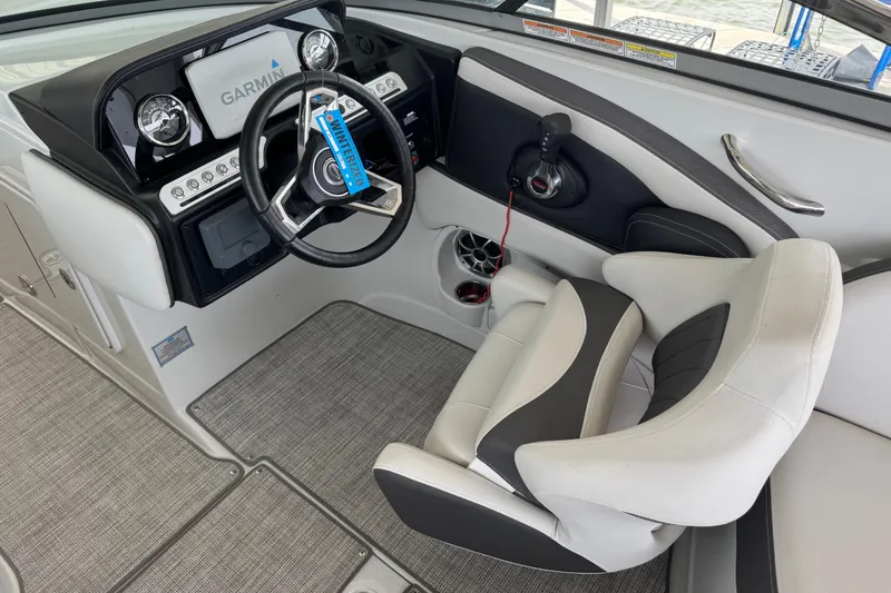 Slide: The Image of Interior of 2022 Crownline 265 SS boat with Garmin navigation system and plush seating. - 12