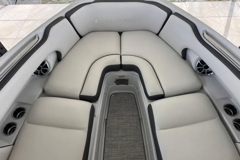 Slide: The Image of 2022 Crownline 265 SS boat interior with plush seating and cup holders. - 14