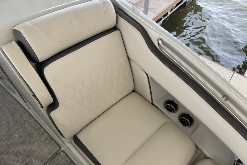 Slide: The Image of Luxurious seating on 2022 Crownline 265 SS boat, featuring elegant beige upholstery and cup holders. - 16
