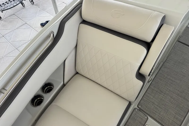 Slide: The Image of Luxurious seating in 2022 Crownline 265 SS boat with diamond-stitched upholstery and cup holders. - 17