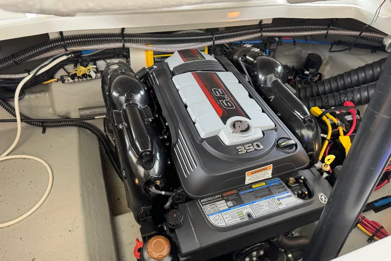 Slide: The Image of Engine compartment of 2022 Crownline 265 SS boat featuring a Mercury 350 engine. - 19