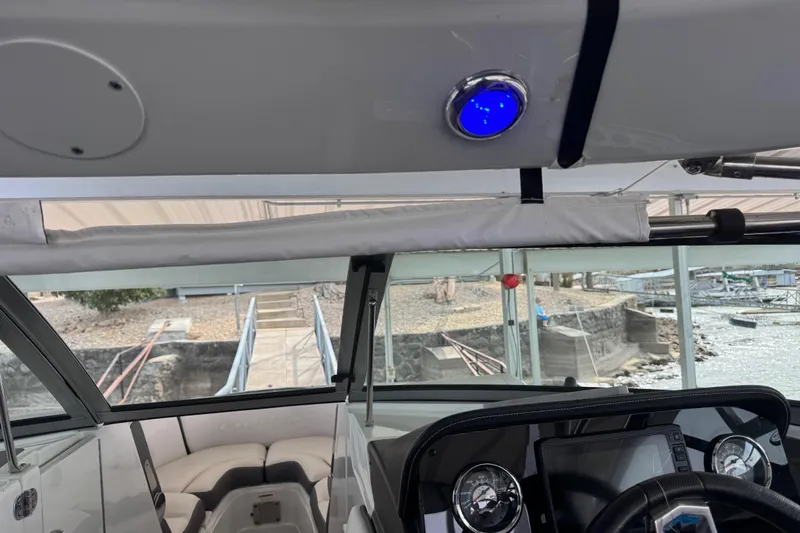 Slide: The Image of Interior view of 2022 Crownline 265 SS boat with dashboard and seating. - 23