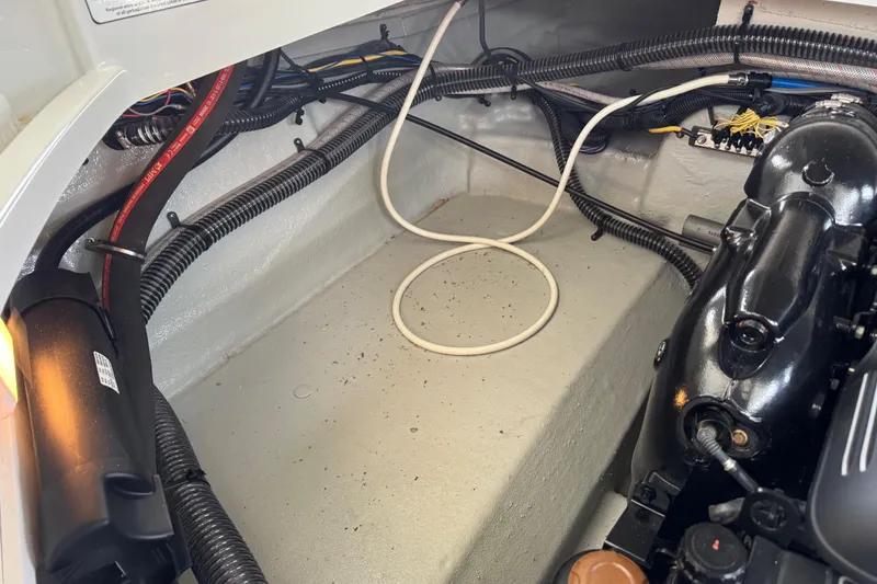 Slide: The Image of Engine compartment of 2022 Crownline 265 SS boat, showcasing wiring and components. - 27