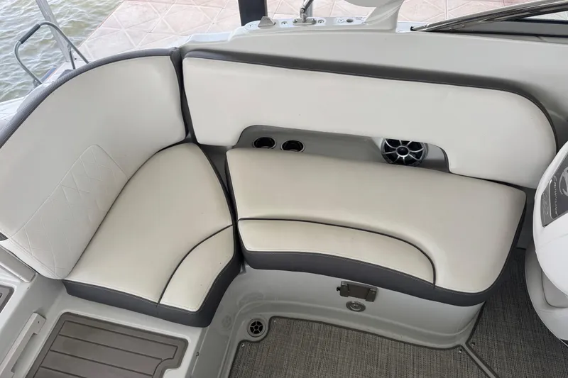 Slide: The Image of 2022 Crownline 265 SS boat interior with cushioned seating and cup holders. - 28