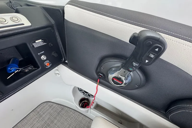 Slide: The Image of Interior controls of a 2022 Crownline 265 SS boat, featuring throttle and trim levers. - 29