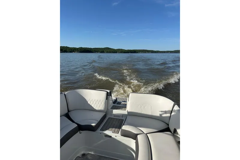 Slide: The Image of 2022 Crownline 265 SS boat interior with lake view and wake trail. - 3