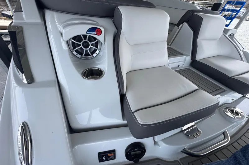 Slide: The Image of 2022 Crownline 265 SS boat interior with cushioned seating and speaker system. - 31