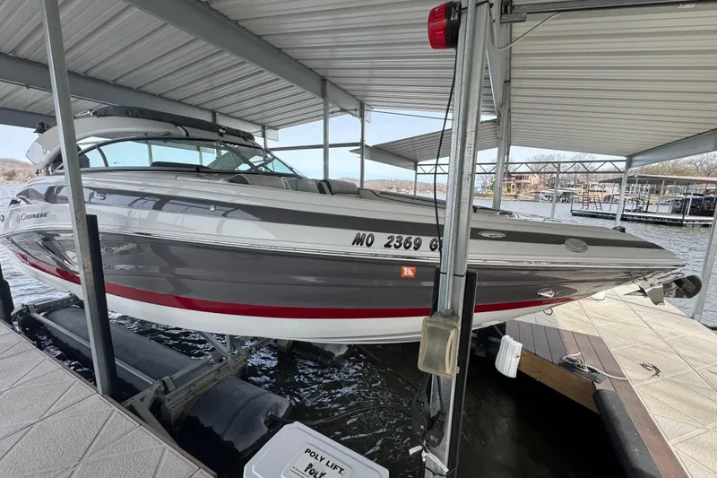 Slide: The Image of 2022 Crownline 265 SS boat docked under a covered marina. - 32