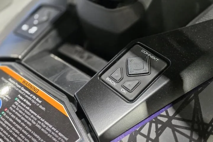 Slide: The Image of Control panel of 2026 Yamaha WaveRunner GP HO with navigation buttons and warning label. - 14