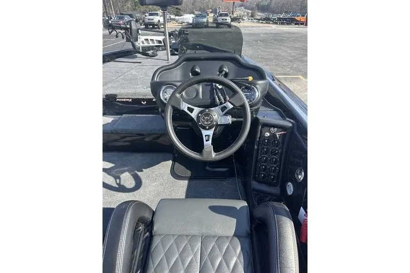 Slide: The Image of Steering console of 2026 Phoenix 919 ZXL boat with modern controls and dashboard. - 10